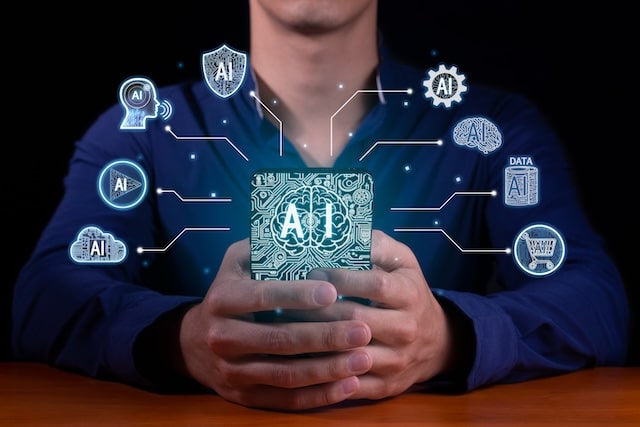 Man holding device glowing with the word AI