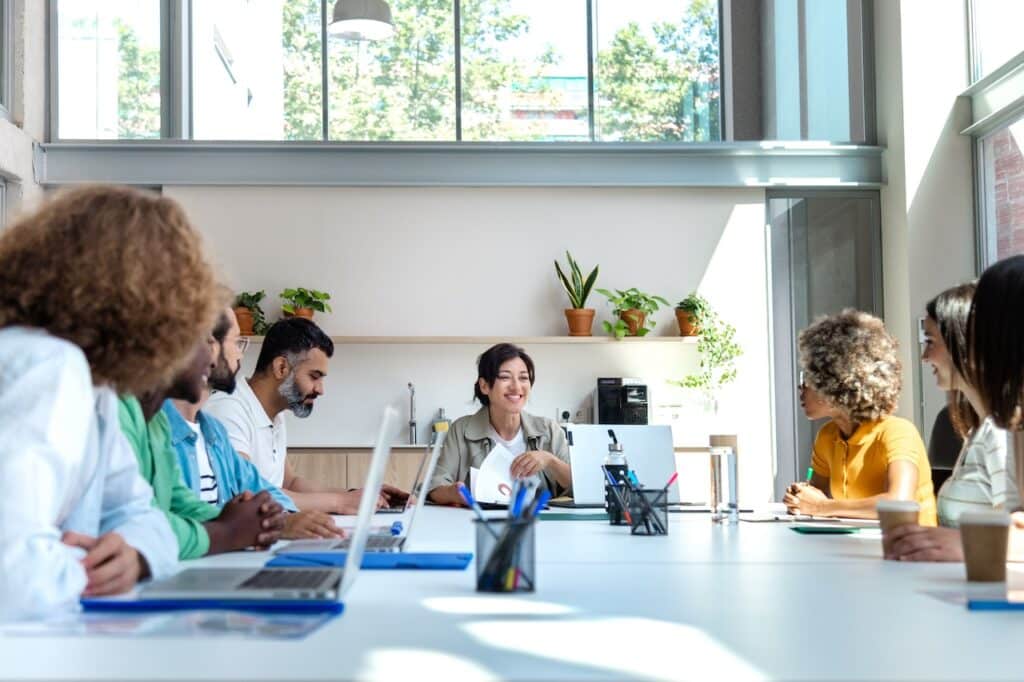 Coworkers sat around conference table with computers