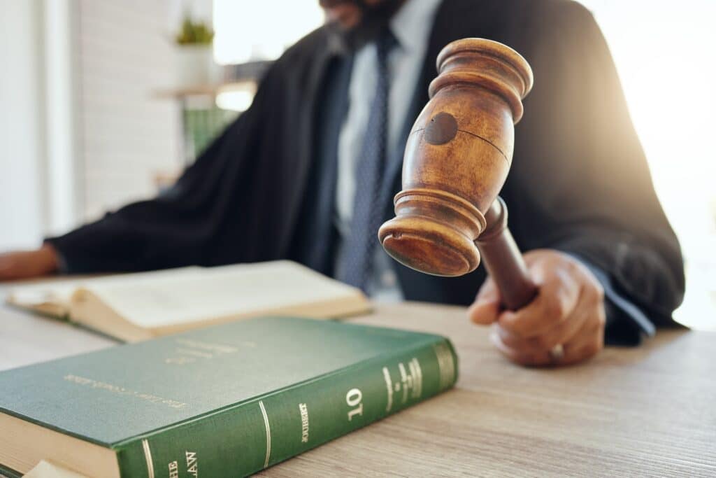 Judge with gavel and law book.