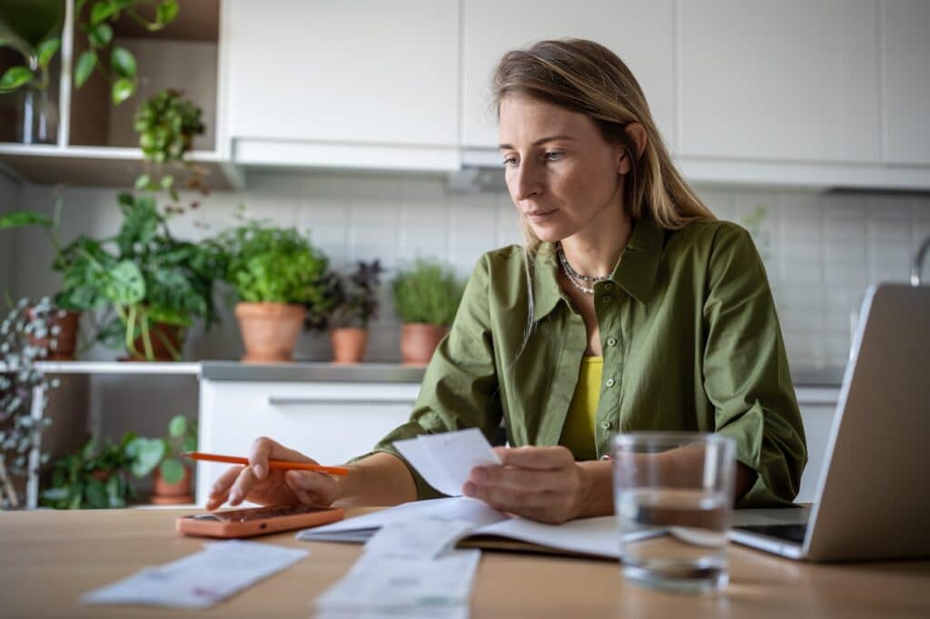 Woman looking at paperwork at home.